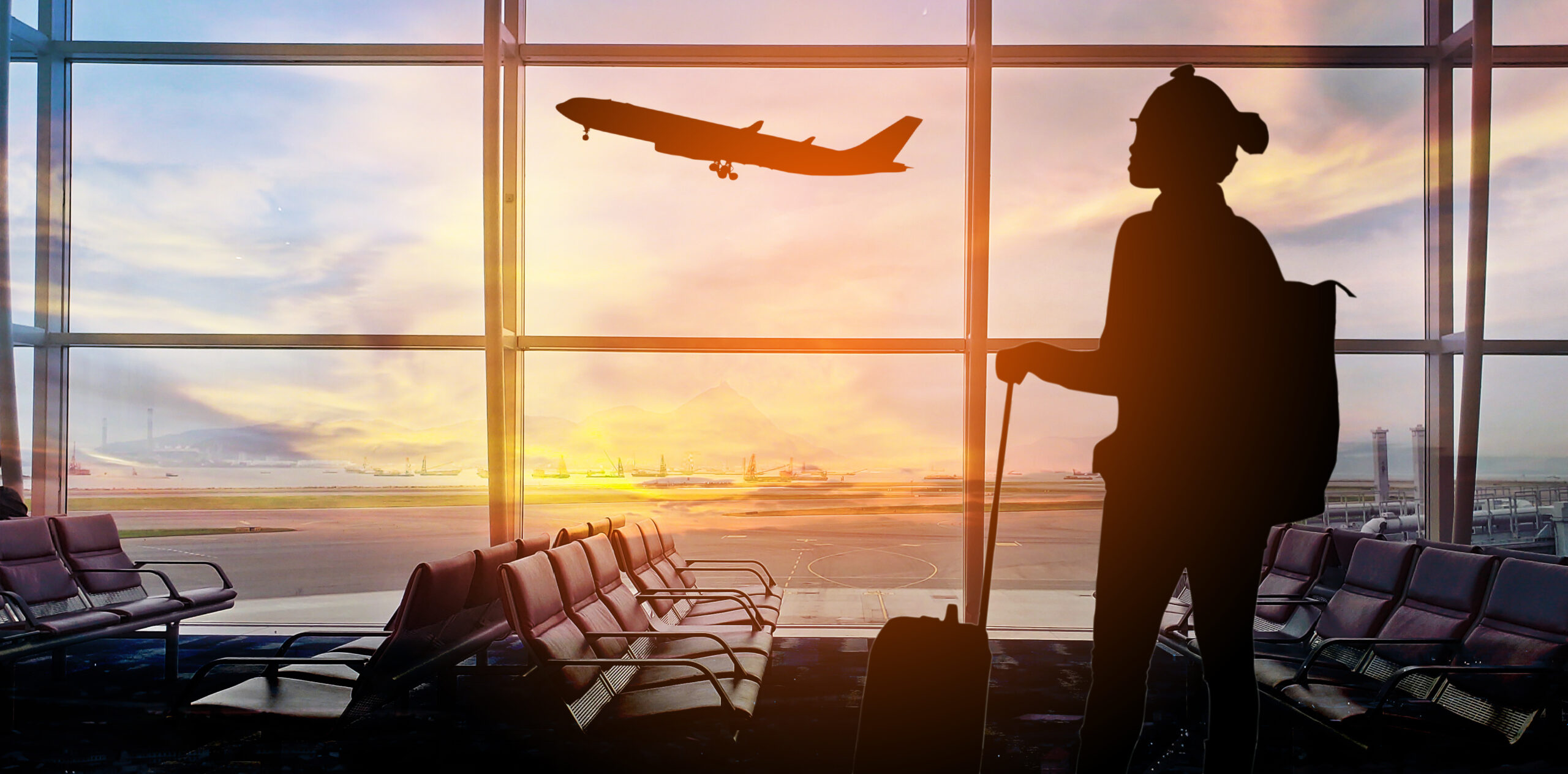 Woman standing in airport watching plane airline security management